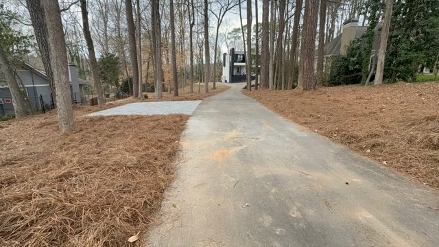 Bare dirt driveway area before hardscape installation