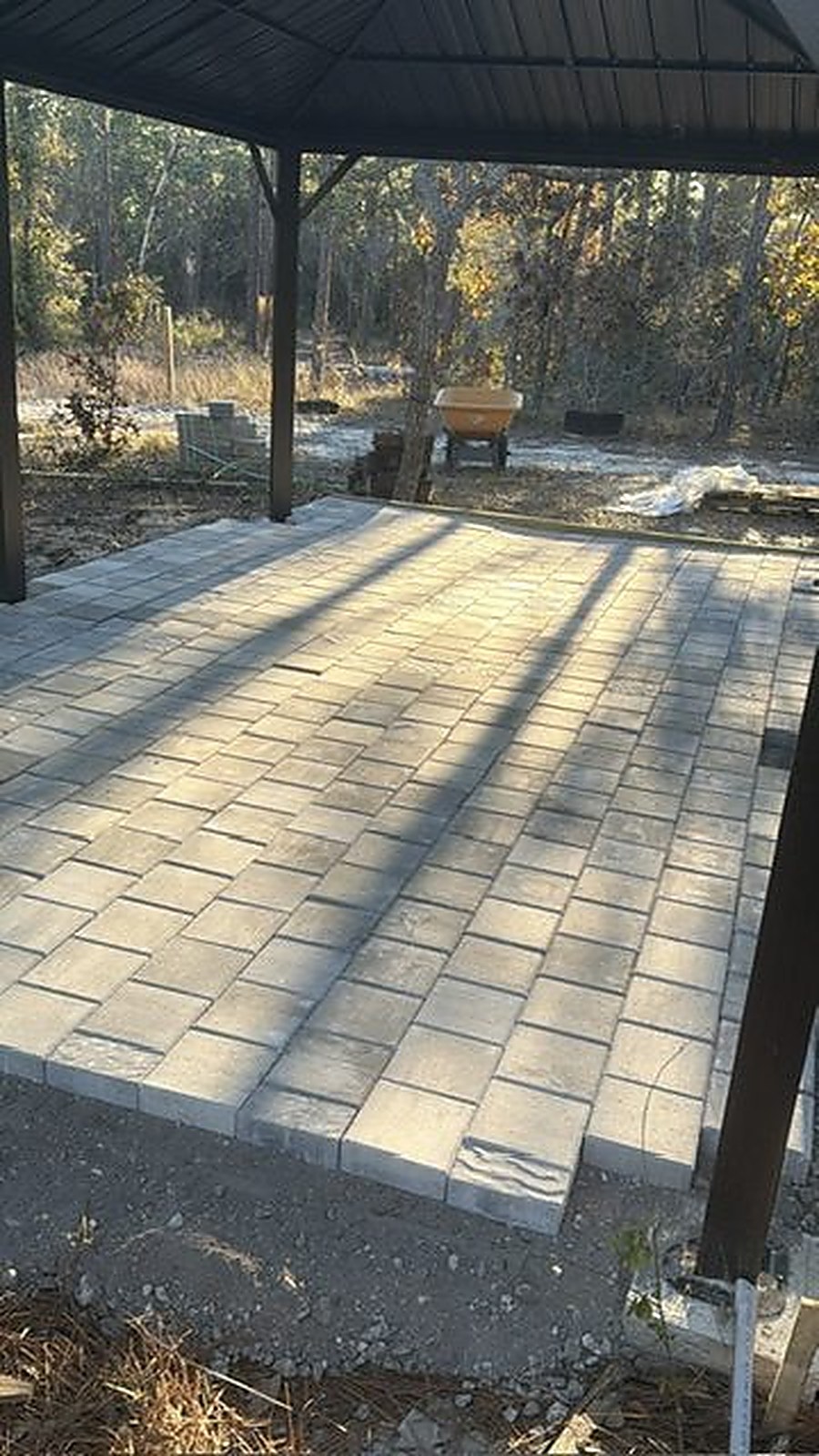 Covered paver patio behind a Tampa Bay home