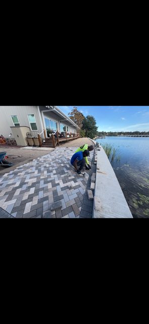 Paver cap installation along a waterfront seawall