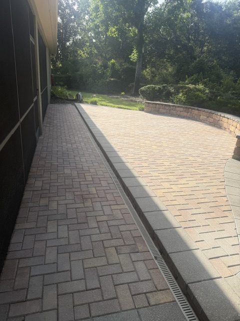 Curved paver driveway apron installed at a residential property